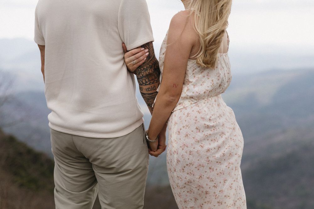 Up close photo of bride and groom holding hands on Preacher's Rock