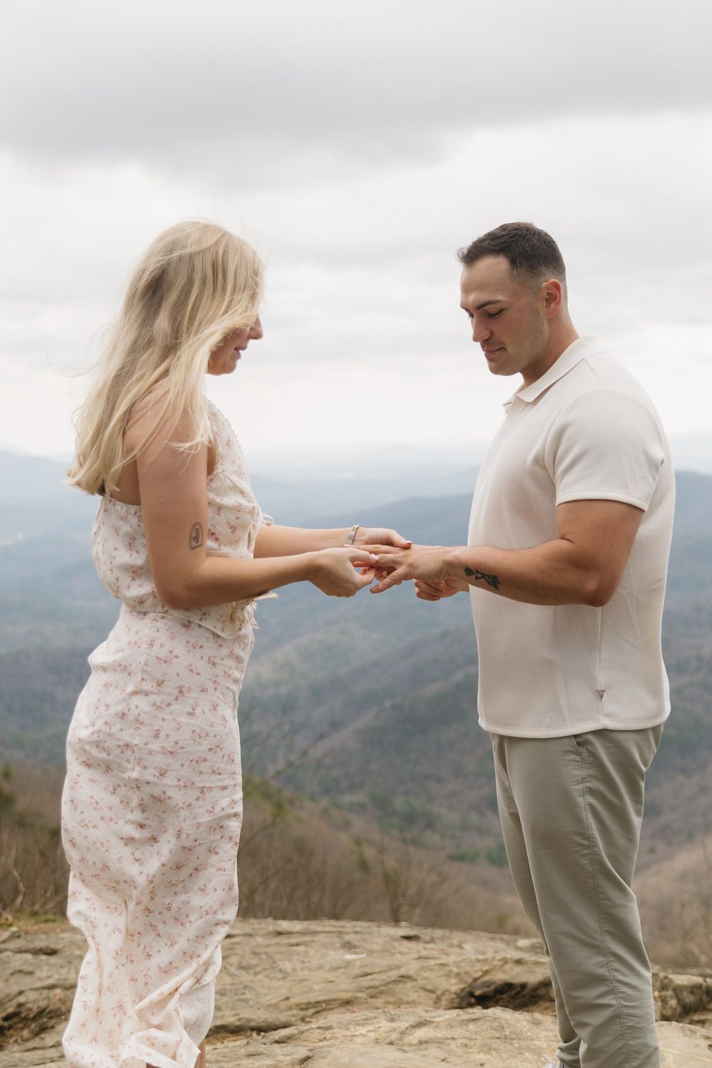 Romantic candid moment with cloudy mountain backdrop in Georgia