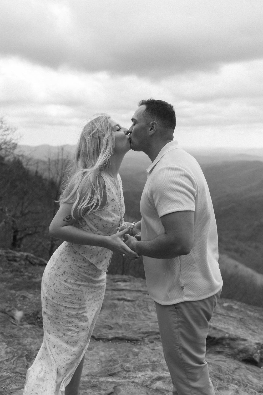 Couple sharing quiet moment with panoramic mountain views behind them