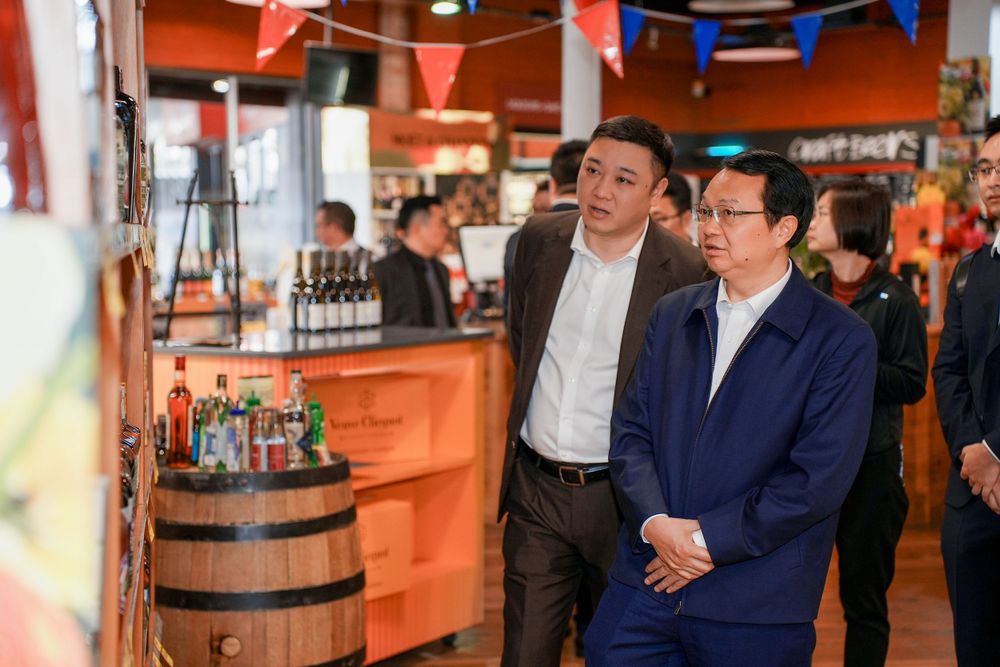 Corporate event photography of a business delegation inspecting a liquor store, by an Auckland commercial photographer.