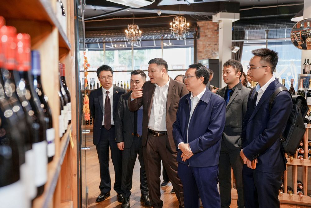 Corporate event photography of a business delegation inspecting a liquor store, by an Auckland commercial photographer.