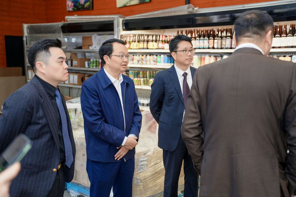 Corporate event photography of a business delegation inspecting a liquor store, by an Auckland commercial photographer.