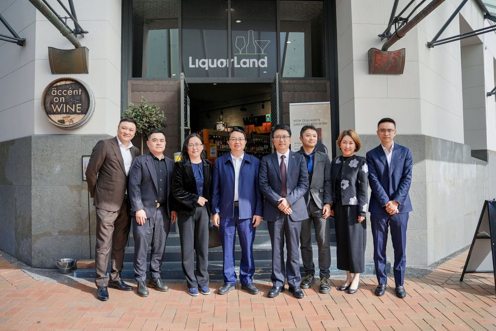 Corporate event photography of a business delegation inspecting a liquor store, by an Auckland commercial photographer.