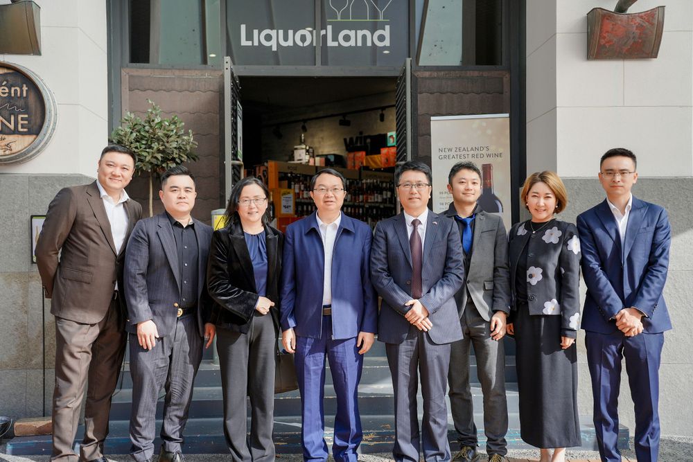 Corporate event photography of a business delegation inspecting a liquor store, by an Auckland commercial photographer.