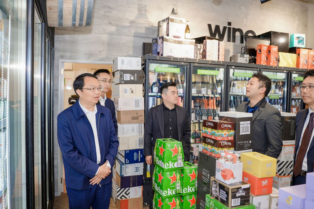 Corporate event photography of a business delegation inspecting a liquor store, by an Auckland commercial photographer.