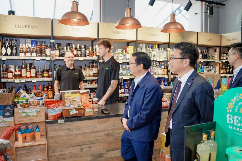 Group photo of a corporate business delegation outside a retail store, captured by an Auckland commercial photographer.