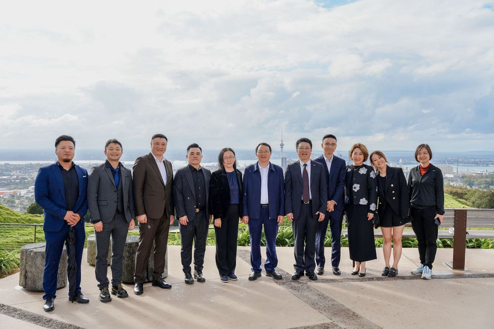 Group photo of a corporate business delegation outside a retail store, captured by an Auckland commercial photographer.Group photo of a corp