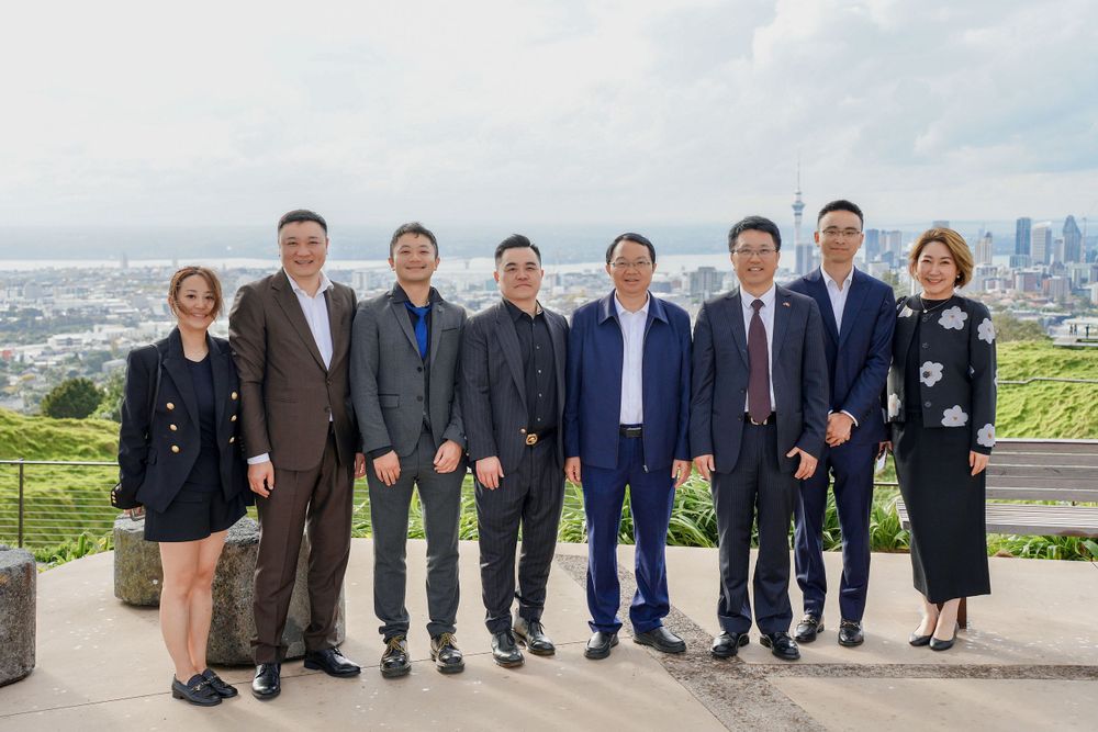 Group photo of a corporate business delegation outside a retail store, captured by an Auckland commercial photographer.