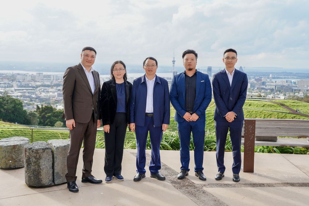 Group photo of a corporate business delegation outside a retail store, captured by an Auckland commercial photographer.