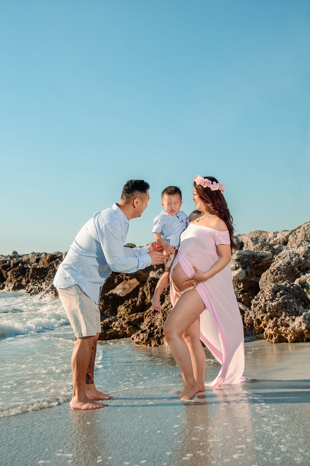 maternity photo of family interacting on beach in new port richey