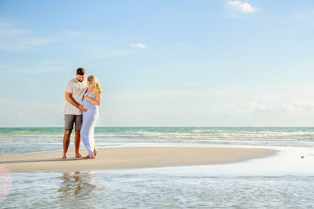 maternity photo of young couple on sandbar in New Port Richey