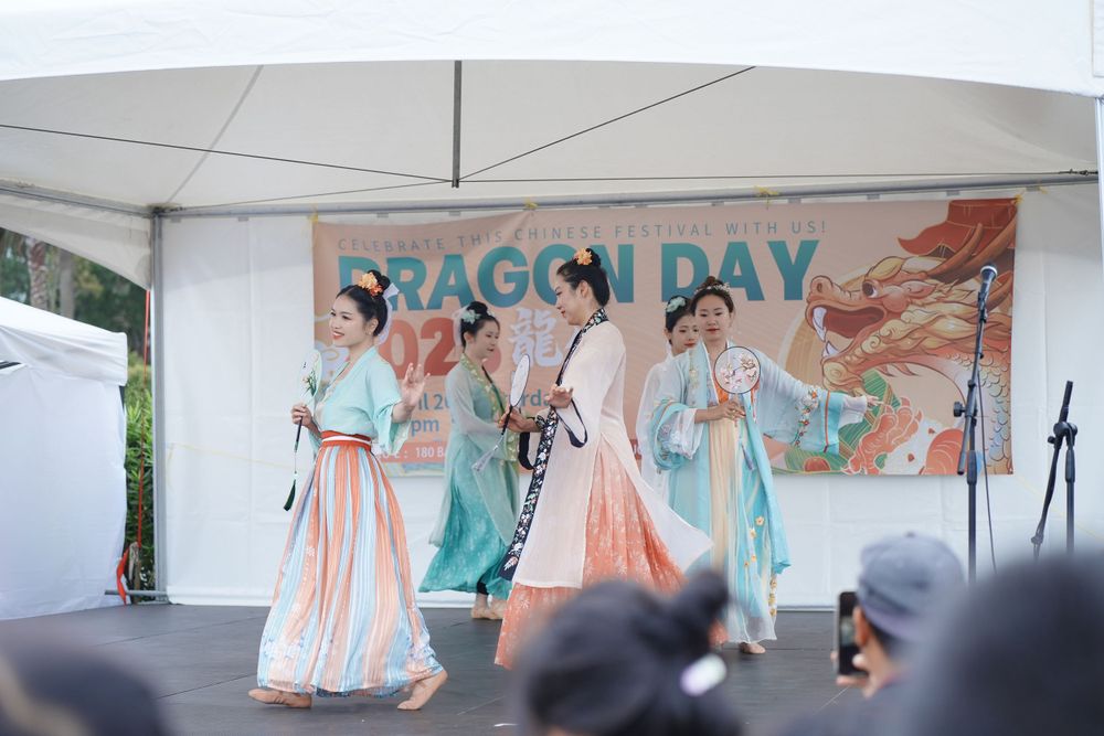 Event photography of a traditional Hanfu dance performance on stage at the Dragon Boat Festival, by an Auckland event photographer.