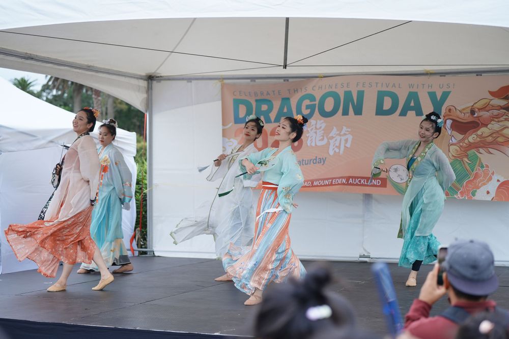 bEvent photography of a traditional Hanfu dance performance on stage at the Dragon Boat Festival, by an Auckland event photographer.