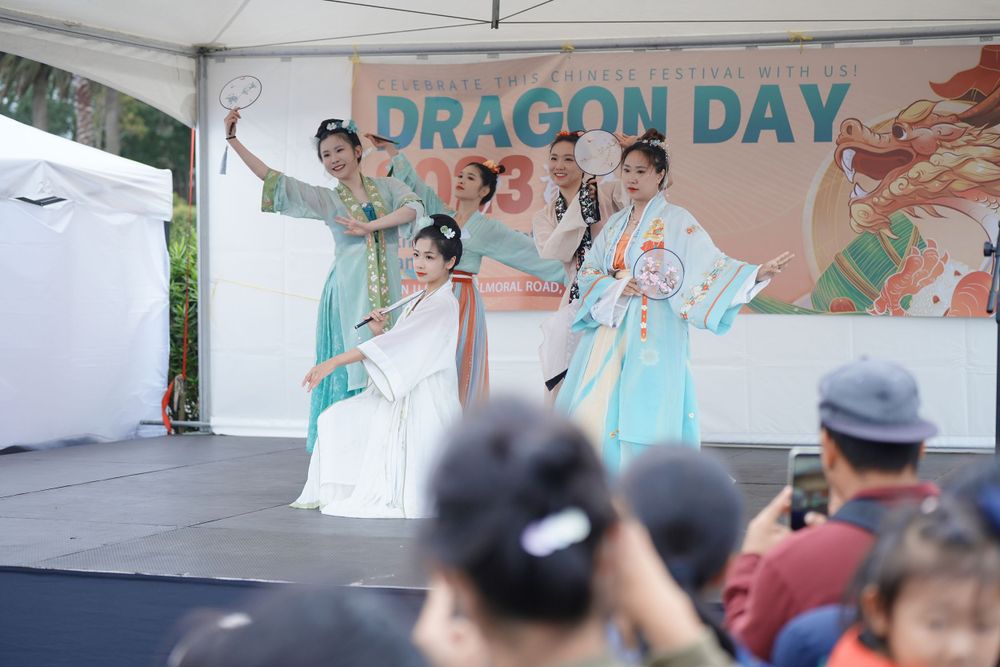 Event photography of a traditional Hanfu dance performance on stage at the Dragon Boat Festival, by an Auckland event photographer.