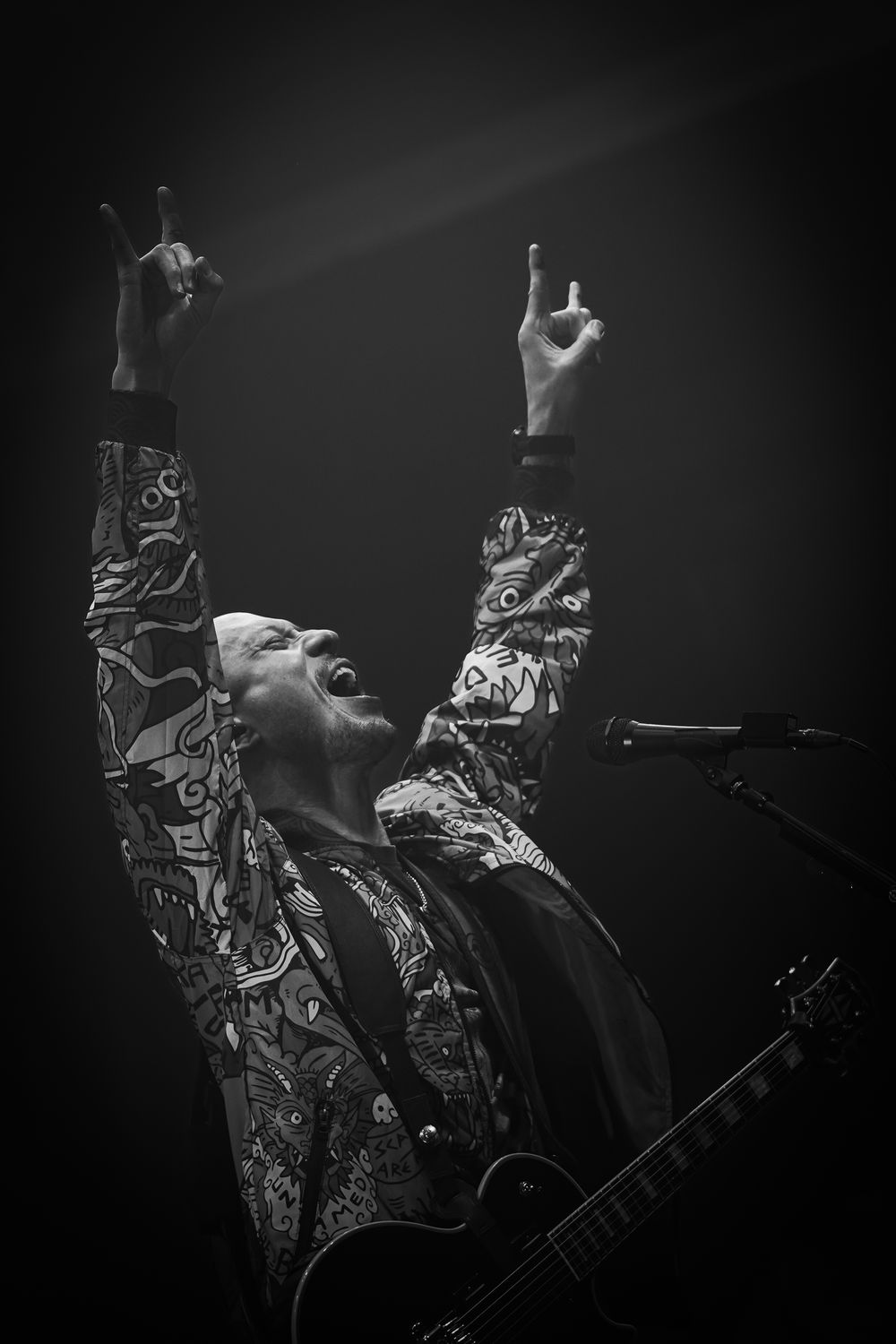Artistic black and white performance photos showing flowing fabric movements against a dark stage.