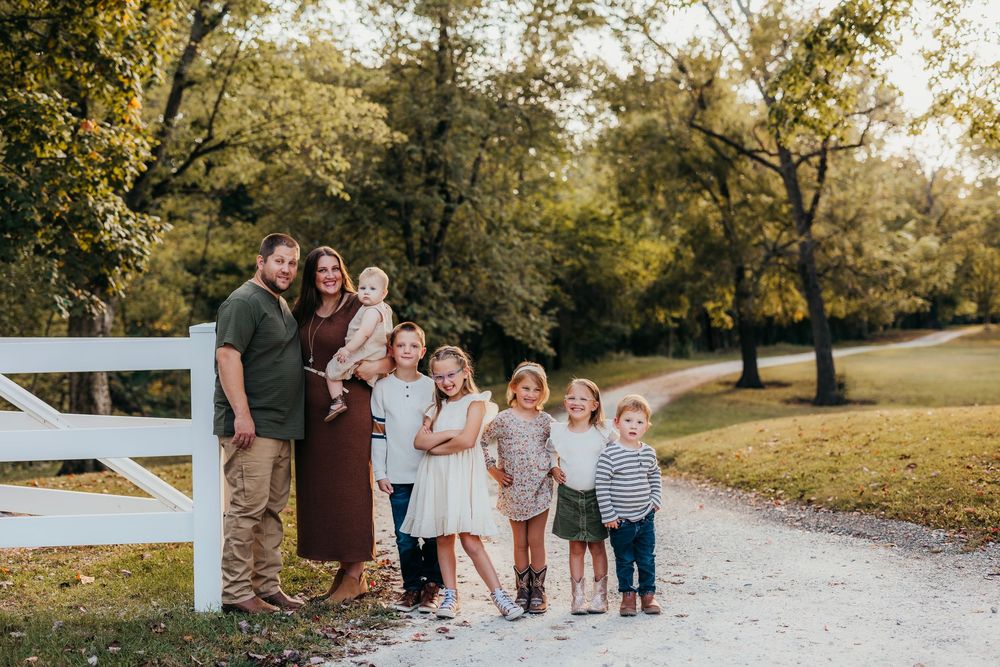 A series of outdoor family portraits taken in a golden-lit park with autumn trees and a gravel path.