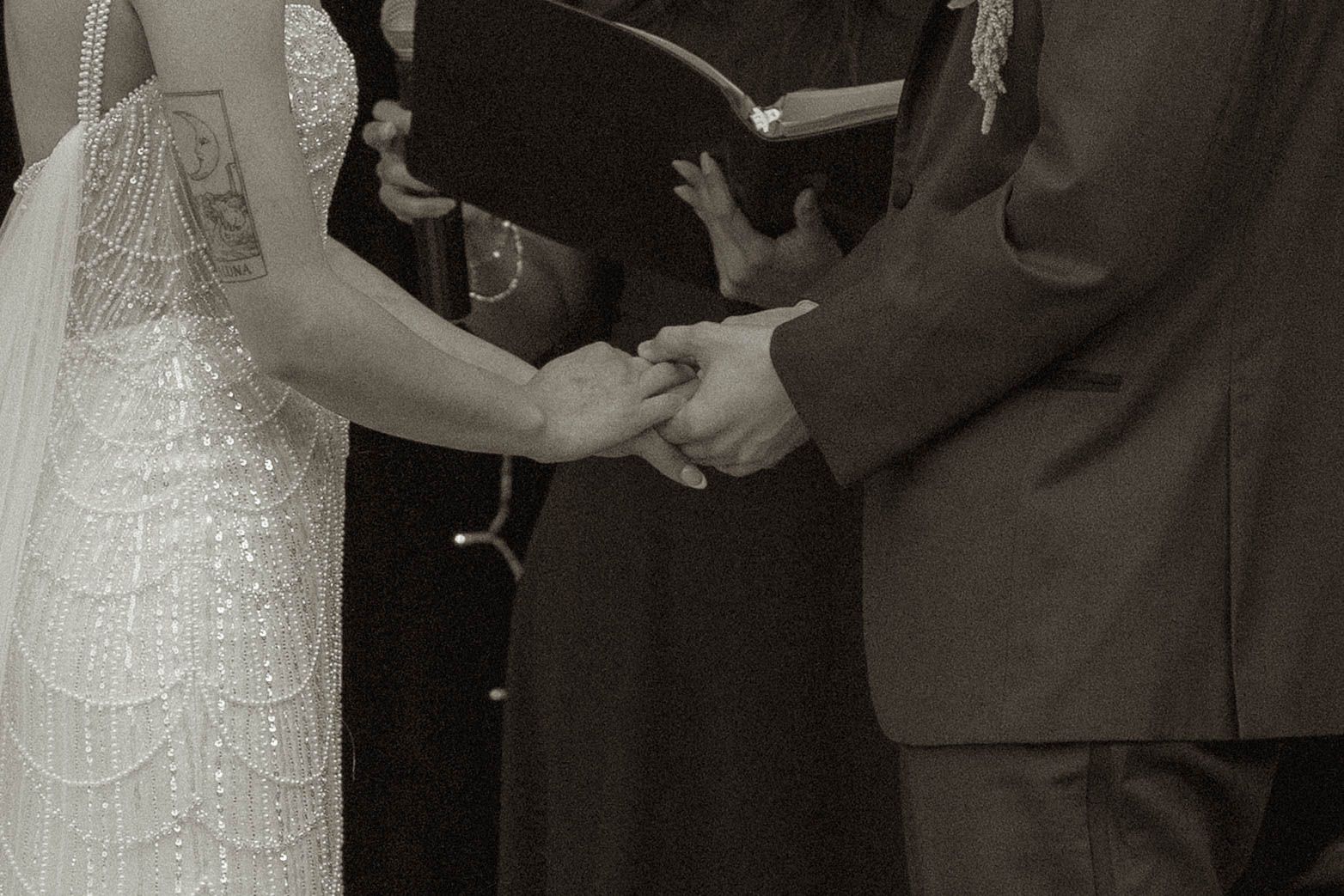 Black and white photo capturing intimate moments during a wedding ceremony.