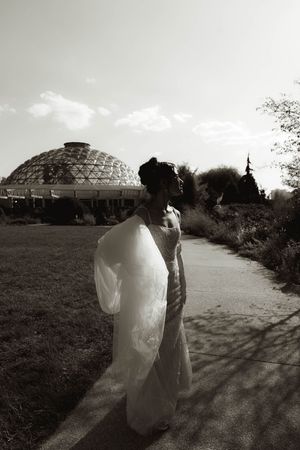 Wedding couple silhouetted against geodesic domes in dramatic black and white photography.