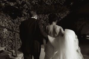 Black and white romantic moment captured during an evening wedding celebration.