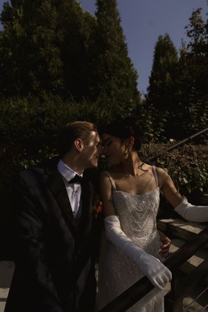 A romantic wedding photoshoot sequence captured at dusk in a garden setting.
