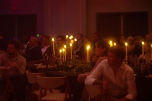 Wedding reception venue at night with glowing candles and ambient lighting.