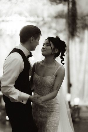 A romantic black and white sequence of a couple dancing together at their wedding reception.