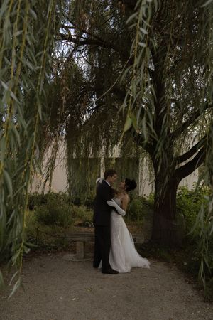 Wedding photography session under the canopy of weeping willow trees.
