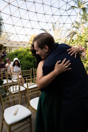 A tender moment captured under a geometric dome ceiling with natural lighting.