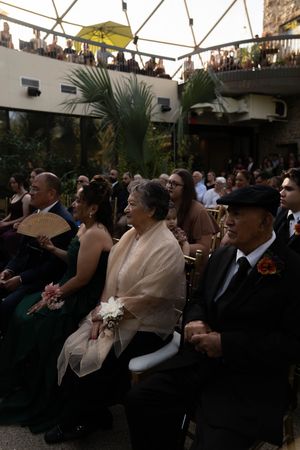 Wedding attendees seated under a geometric dome ceiling during an evening ceremony.