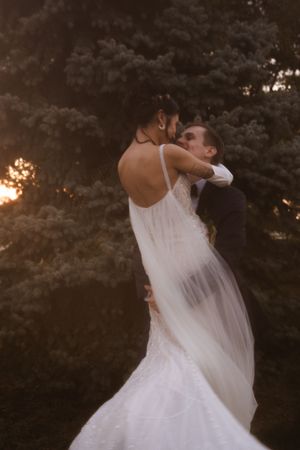Romantic dance sequence showing couple spinning in wedding attire at dusk.