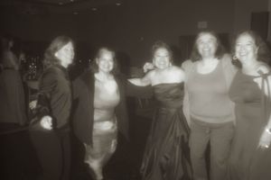 Group of party guests posing together at a celebratory event.