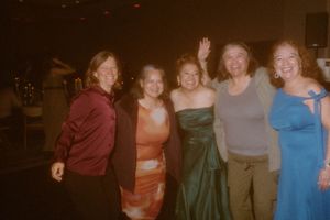 Guests enjoying themselves on a lively dance floor at an evening celebration.