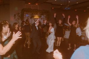 Lively dance floor scene with guests celebrating at a nighttime event.