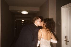 Wedding guests mingling in a softly lit indoor venue space.