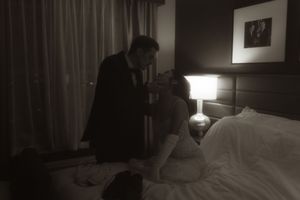 Hotel room interior with table lamps and wall art creating ambient lighting.