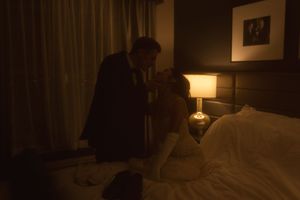 Warm-toned interior shot of a hotel room with decorative lighting fixtures.