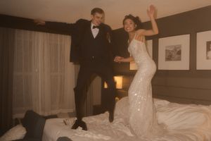 A joyful dance scene unfolds between a couple in formal wear.