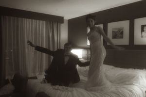 A romantic dance sequence between a couple in a hotel setting.