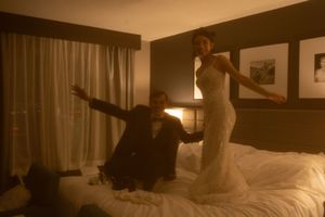 A sepia-filtered photo shows a couple dancing in their hotel room.
