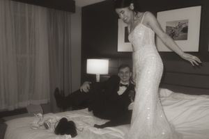 A black and white photo captures a couple's dance in their hotel room.