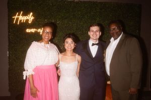 Group photo of guests in formal attire at an evening event.