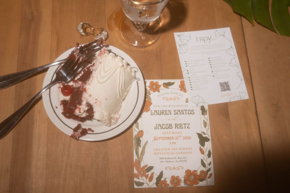 Empty plates and wedding place cards on wooden table after reception dinner.