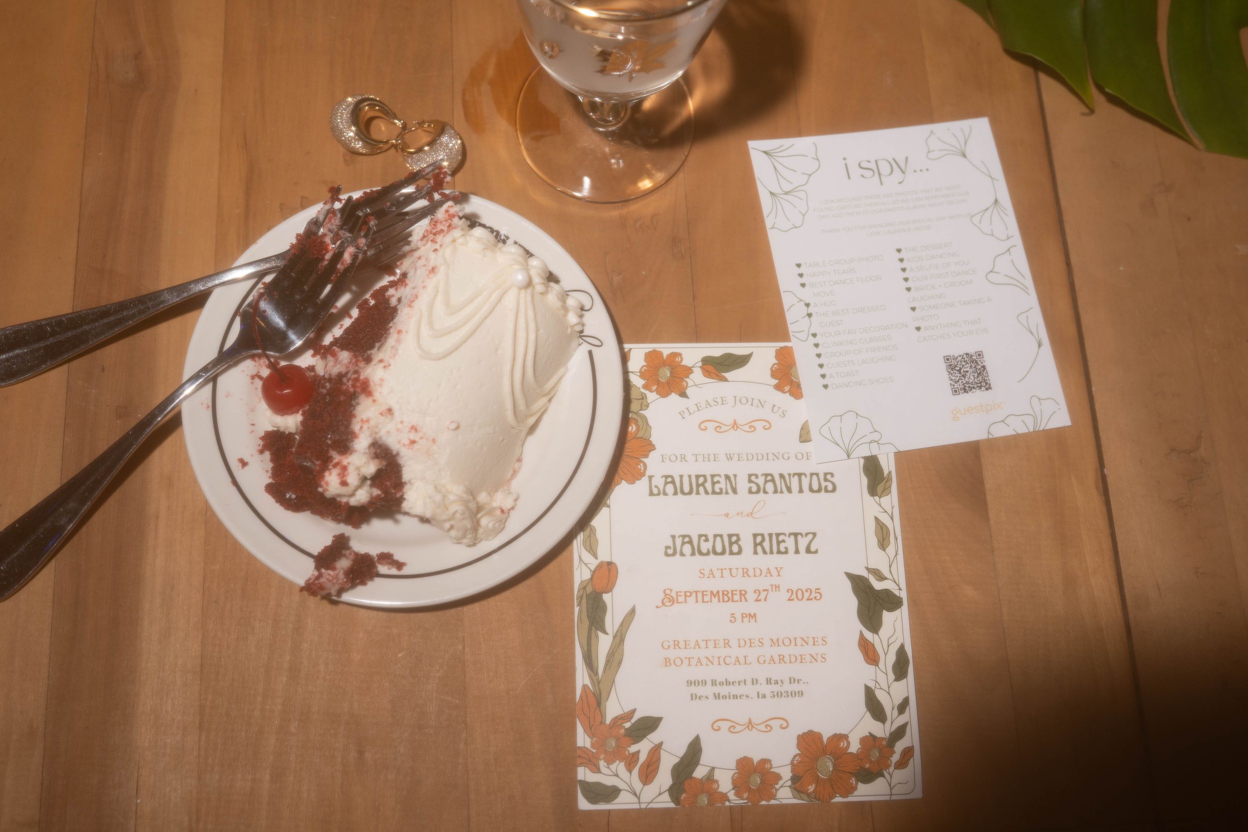 Empty plates and wedding place cards on wooden table after reception dinner.