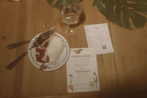 Table settings with tropical leaves and place cards at a formal dinner.