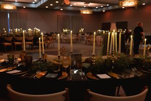 Elegant evening reception setup with warm lighting and formal table settings.