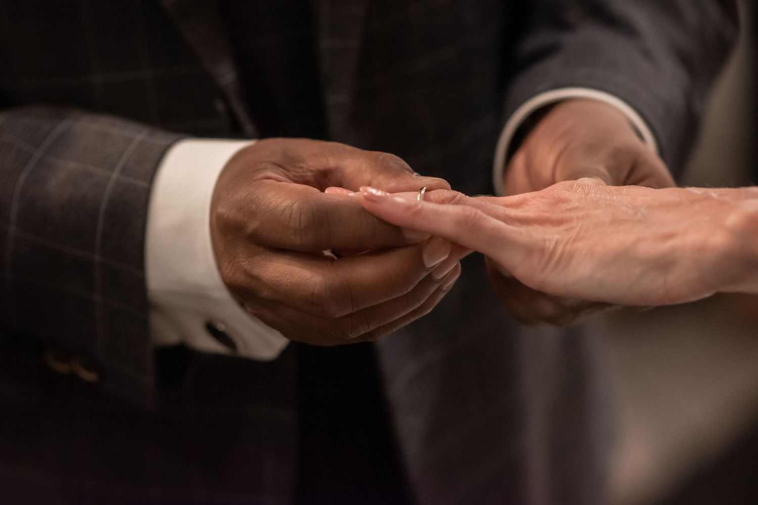 Exchanging rings during a ceremony at a Manchester wedding by Cheshire wedding photographer Michael Pardoe