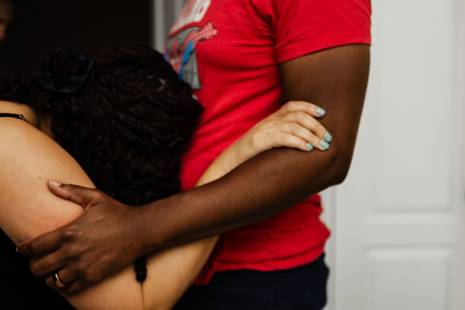 A first time mom embraces her partner as she experiences a contraction. A photograph shot by New Orleans Birth Photographer Autumn Hutton.