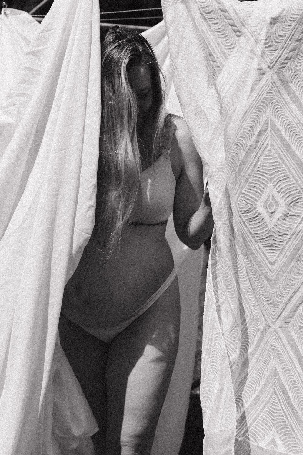 Black and white photo sequence showing someone peeking through white lace curtains with geometric patterns.