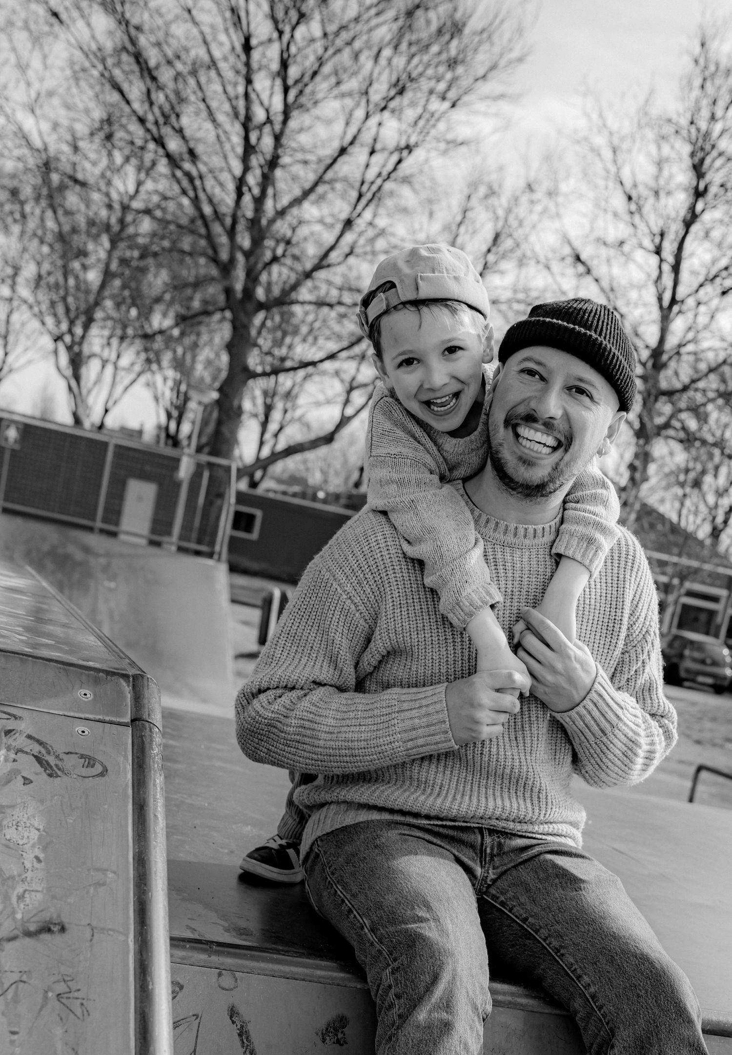 Black and white series of candid moments between two people sitting at a skate park.