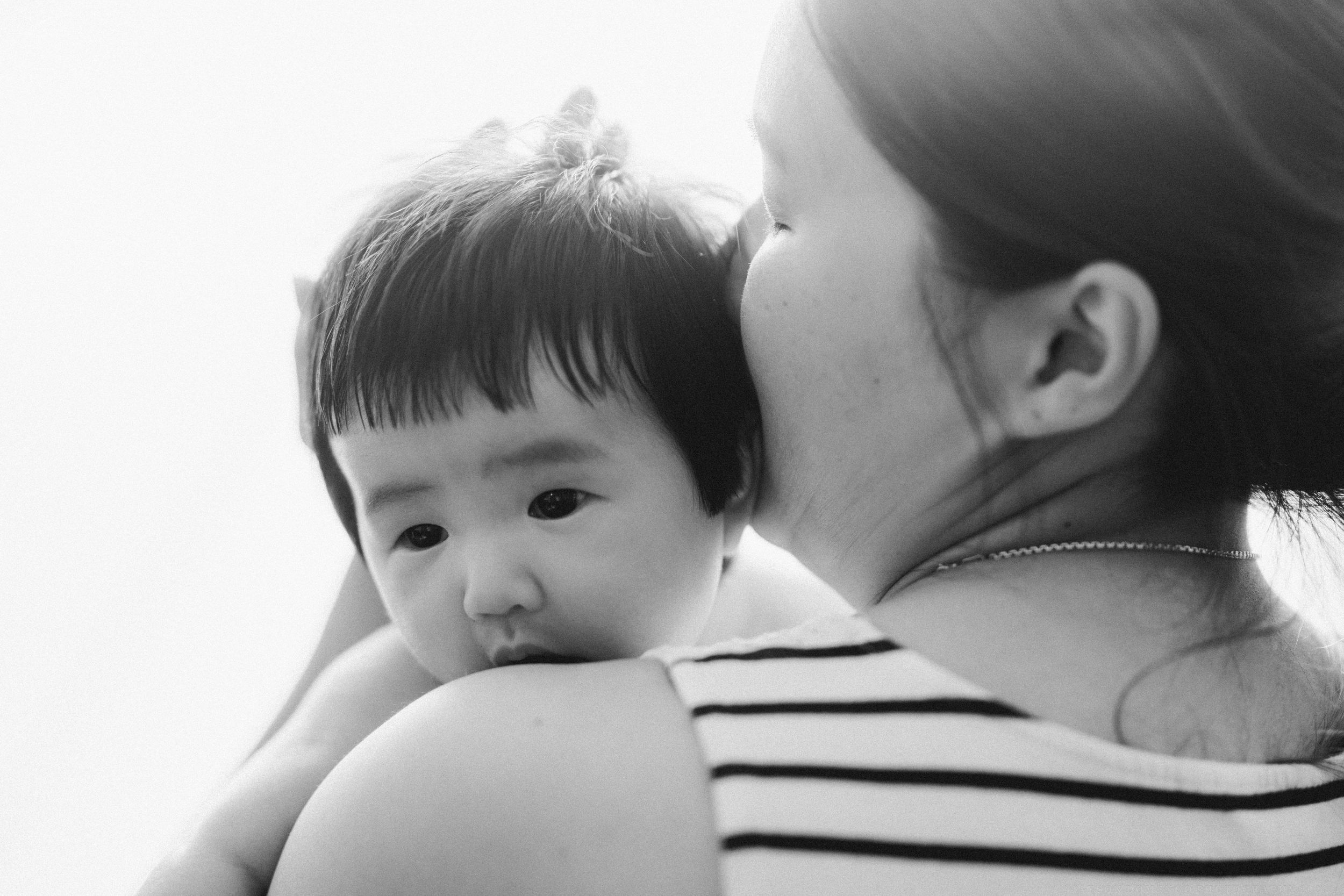Black and white portrait of tender parent-child bonding moment.
